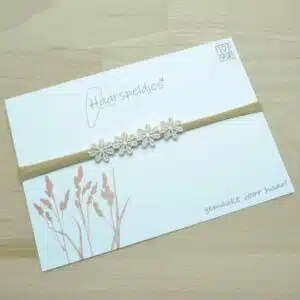 Haarbandje met vier beige bloemetjes